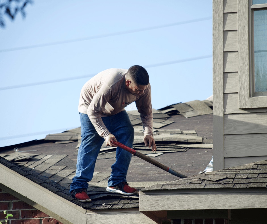A roofer replacing a roof
